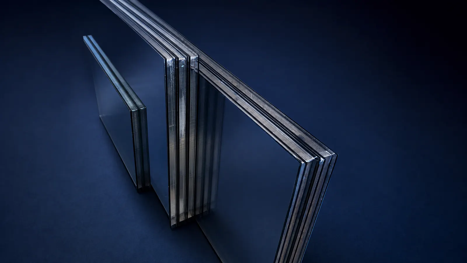 Sealed insulated glass units showing their multi-pane edges with warm-edge spacer bars and sealant bands